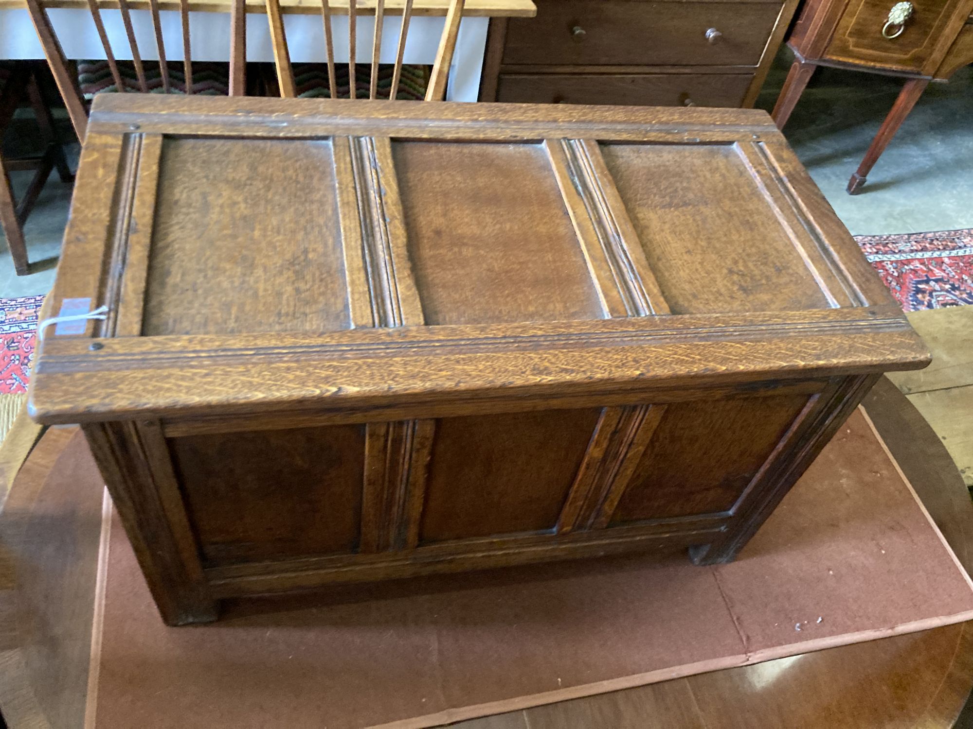 A small 18th century style panelled oak coffer, length 76cm, depth 40cm, height 45cm